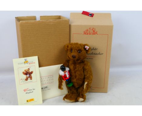 Steiff - A boxed limited edition Teddy Bear with Nutcracker #37955 russet. Item stands at 26cm tall and appear in near mint c