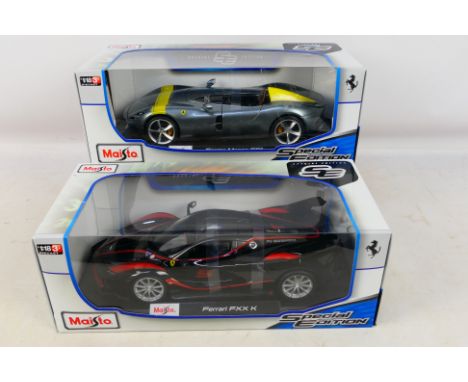 Maisto - 2 x boxed Ferrari models in 1:18 scale, an FXX K in black # 46629 and a Monza SP1 in grey # 12326. They appear Mint 