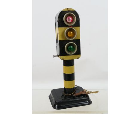German - A very unusual tinplate Traffic Light with battery powered lighting and a clockwork mechanism to cycle through the d