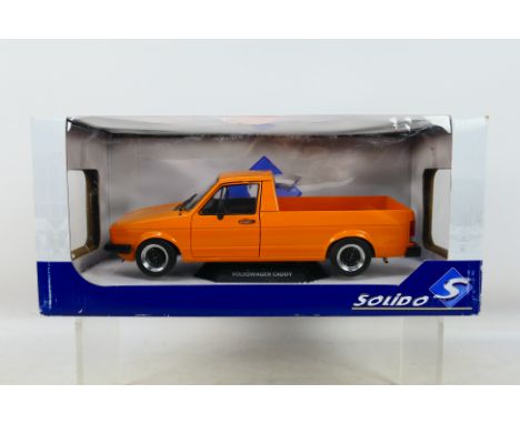 Solido - A boxed Volkswagen Caddy MkI in orange in 1:18 scale # S1803502. The car appears mint in a Good box with light stora