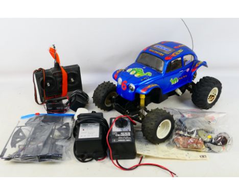 Tamiya - An unboxed vintage Tamiya 1:10 scale radio control Monster Beetle # 58618. It shows signs of age and use and has som