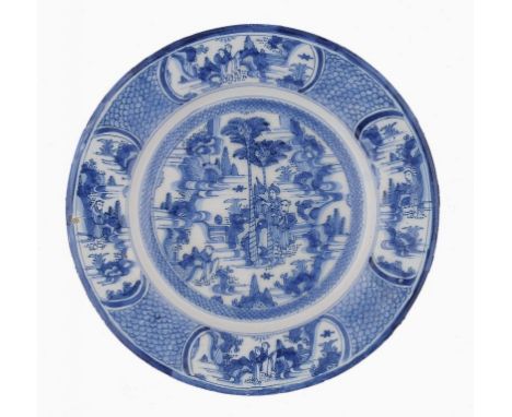 A CONTINENTAL TIN GLAZED EARTHENWARE DISH, PROBABLY GERMAN, C1760-80 painted with chinoiseries on a scale patterned ground, t