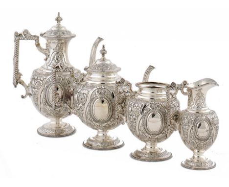 A VICTORIAN SILVER TEA AND COFFEE SERVICE chased in high relief with fruit and flowers, coffee pot 29cm h, by Walker & Hall, 