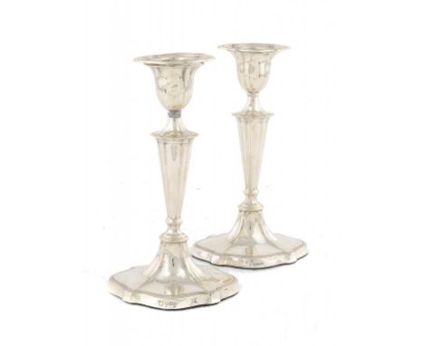 A PAIR OF VICTORIAN SILVER CANDLESTICKS with nozzles, 18cm h, by D & M Davis, Sheffield 1900, loaded ++On one candlestick, on