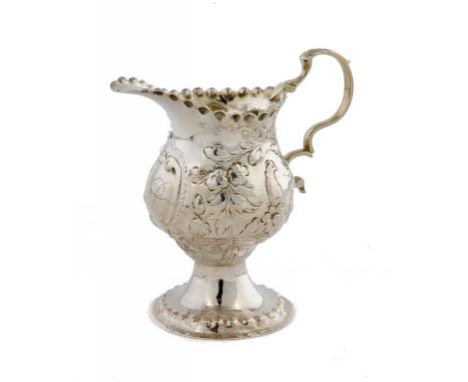 A GEORGE III SILVER REPOUSSÉ OGEE CREAM JUG with a bird on a branch to both sides, 9.5cm h, maker's mark rubbed, W-, London 1