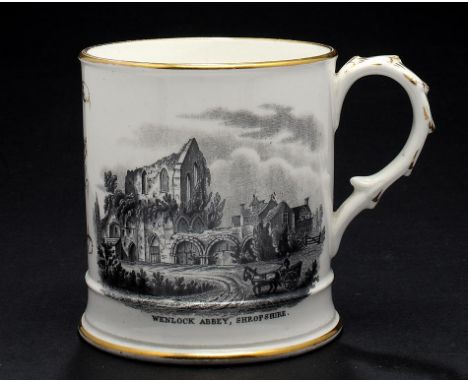 A COALPORT MUG, 1863-75 printed in black with two views of Wenlock and Buildwas Abbeys and inscribed in gilt with the initial
