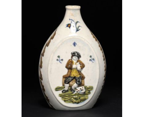 A PRATTWARE FLASK, C1810 moulded to either side with a man seated on a barrel, a glass and pipe or jug in hand, 16.5cm h ++In