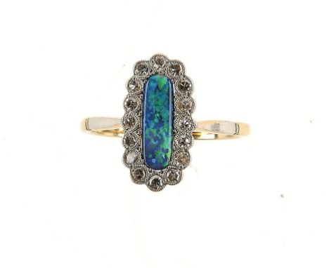 A BLACK OPAL AND DIAMOND CLUSTER RING, C1930 in gold, size S ++Under magnification, the opal with a few light scratches from 