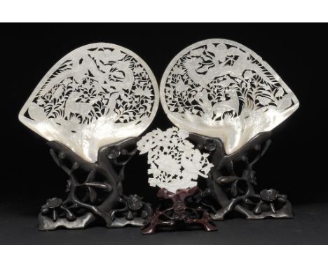 A PAIR OF CHINESE MOTHER OF PEARL CARVINGS, KANGXI MARK, LATE 19TH/EARLY 20TH C 20.5cm w with engraved detail, wood stands an