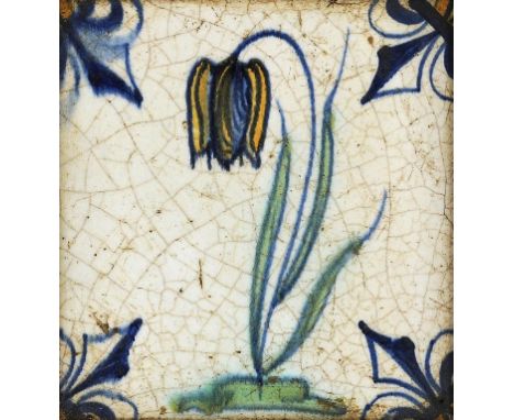 A DUTCH DELFTWARE POLYCHROME TILE, 18TH C painted with a tulip and fleur de lys, 11.5cm square, framed ++Surface crazing and 