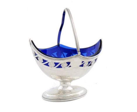 A GEORGE III SILVER NAVETTE SHAPED AND PIERCED SUGAR BASKET with swing handle, blue glass liner, 16.5cm h, by Henry Chawner, 