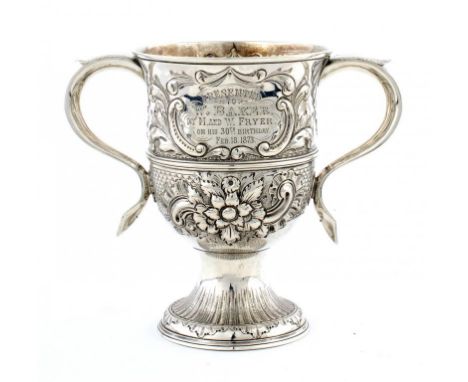 A GEORGE III SILVER CUP later chased, on spume foot, 15cm h, maker WC, a pellet between, probably William Collings, London 17