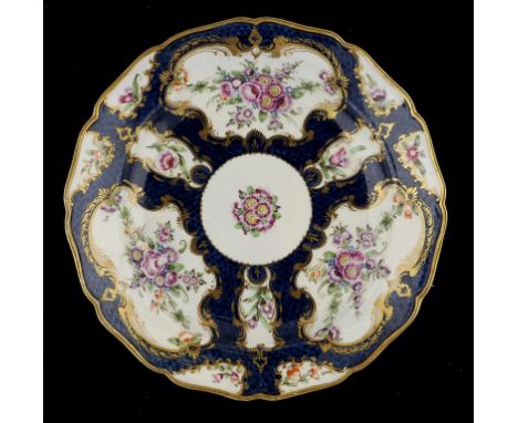 A WORCESTER SCALE BLUE GROUND PLATE, C1770 23.5cm diam, crescent mark ++In fine condition with some extremely minor wear only
