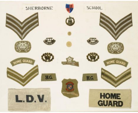 A FRAMED DISPLAY OF BRITISH ARMY BADGES AND CLOTH INSIGNIA, C1940 comprising two brass OTC SHERBORNE shoulder titles, Dorsets