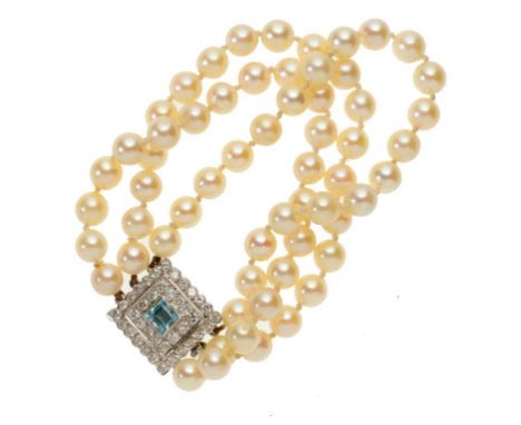 A CULTURED PEARL THREE STRAND BRACELET, C MID 20TH C of approx 7mm cultured pearls with aquamarine, diamond and white gold cl