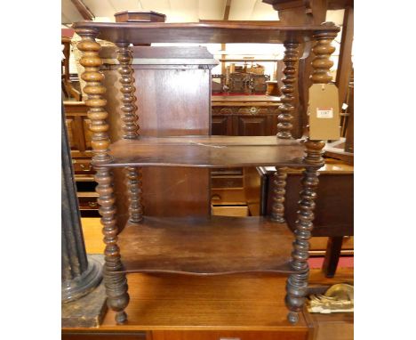 A mid-19th century rosewood shaped top three-tier whatnot, raised on bobbin turned supports, h.76.5cmStructurally unsteady, n
