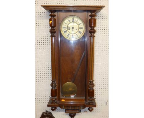 A circa 1900 walnut Vienna drop trunk wall clock, with pendulum, height 103cm
