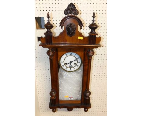 An early 20th century walnut Vienna drop trunk wall clock, with pendulum, height 85cm