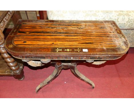 A Regency calamander, rosewood cross banded and brass inlaid fold-over baize lined D-shaped card table, raised on shaped supp