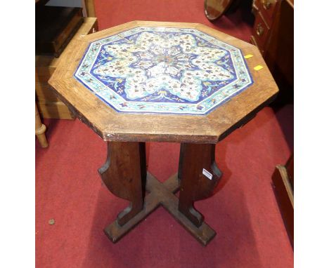 An early 20th century oak and Isnik tile-top inset octagonal occasional table, raised on flat-sided supports, w.51cm