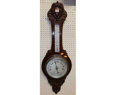 A floral relief carved oak aneroid two-dial wheel barometer, height 89cm