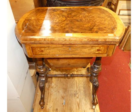 A mid-Victorian figured walnut crossbanded and further satinwood inlaid fold-over games table, having a swivel top, the inter