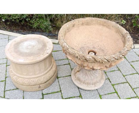 A reconstituted stone floral decorated circular footed garden planter, on partially fluted base, overall height 85cm, dia. 55