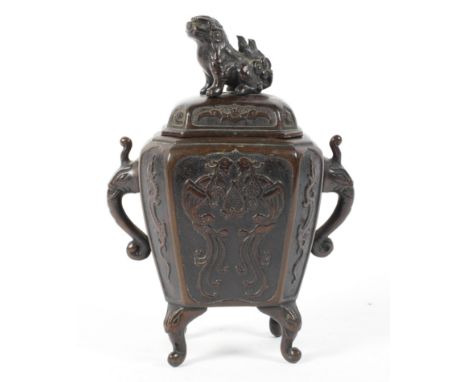 A Chinese Qing dynasty bronze lidded incense burner decorated in relief with twin phoenix and archaic dragons, with zoomorphi