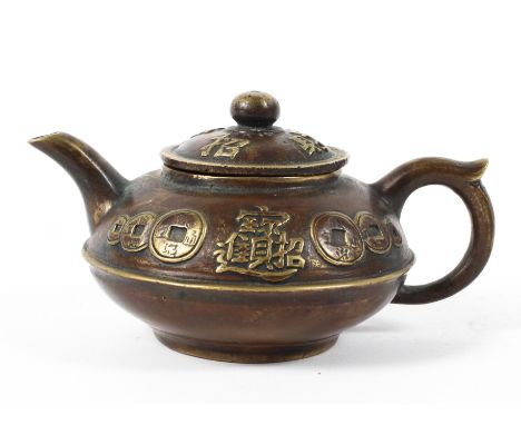 A small Chinese bronze teapot decorated in relief to the lid and body with Chinese characters and coins, four-character mark 