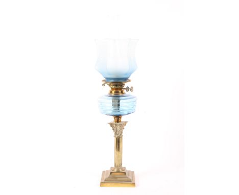 An Edwardian blue glass and brass mounted oil lamp, with etched faceted shde above Duplex burner and blue ribbed resevoir, on