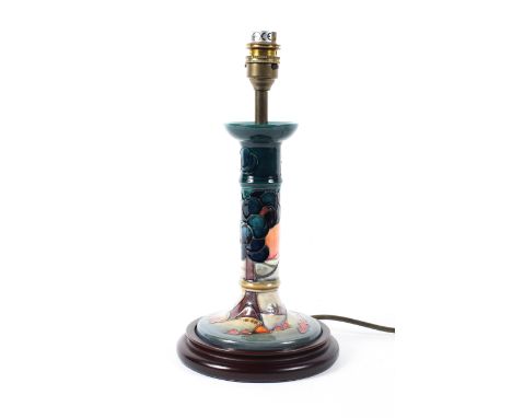A Moorcroft blue-ground lamp base, on turned wooden base, electrified, 23 cm high 