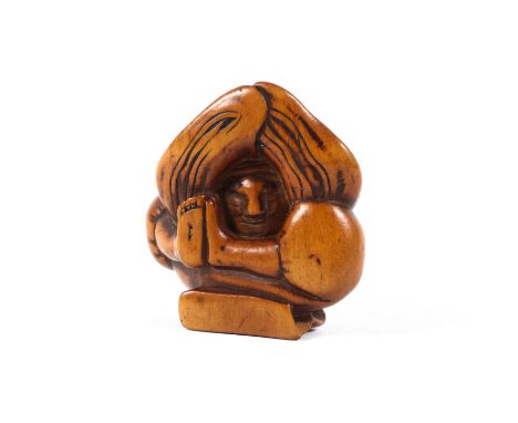 A Meiji dynasty wood netsuke of a dancer crouching with his head placed between his arms outstretched on the ground, length 4