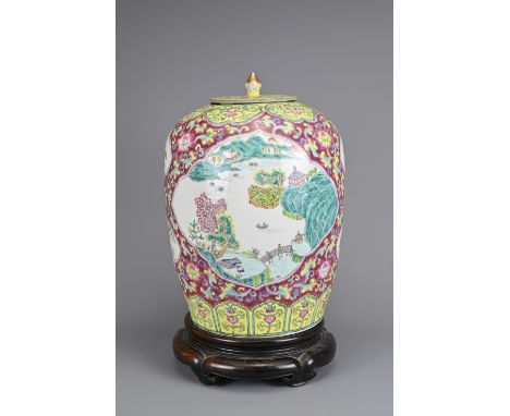 A VINTAGE CHINESE RUBY GROUND PORCELAIN JAR WITH COVER, 20TH CENTURY. Ovoid jar decorated with famille rose enamels of landsc