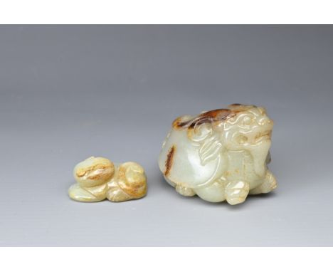 A CHINESE CARVED JADE MYTHICAL BEAST AND A CAT. The beast of mottled brown pale jade, carved as a dragon-turtle, the cat of s