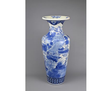 A LARGE JAPANESE BLUE AND WHITE PORCELAIN IMARI WARE VASE, EARLY 20TH CENTURY. Of baluster form decorated with birds in lands