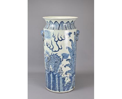 A LARGE CHINESE BLUE AND WHITE PORCELAIN VASE. Heavily potted of cylindrical form tapered towards the foot with two lion mask