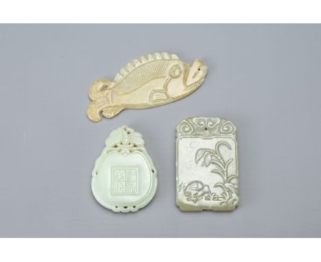 THREE CHINESE CARVED JADE PENDANTS. Comprising: a fish carved with scales, its mouth pierced for suspension, a rectangular pe