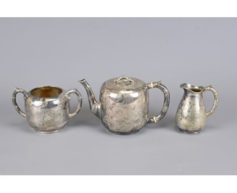 A SILVER PLATED TEA SET, 19TH CENTURY. To include a teapot, sugar pot and creamer. Each decorated with bamboo form handle and