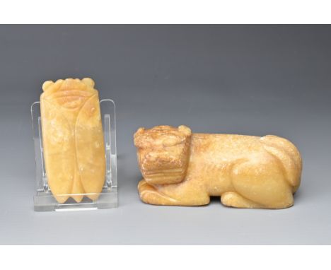 A CHINESE CARVED JADE CICADA AND A DOG. Each of mottled pale amber-brown hue, the dog recumbent, 8.3cm long and the cicada 6c