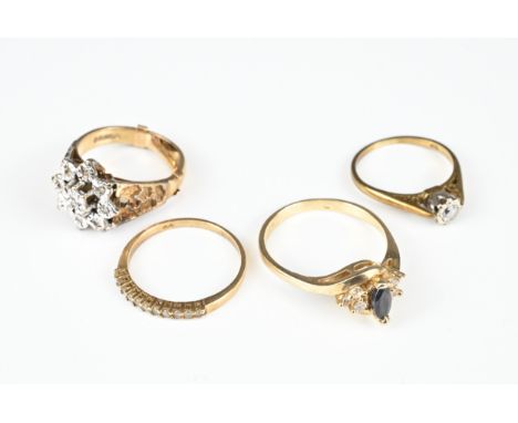 FOUR VARIOUS 9CT YELLOW GOLD STONE SET RINGS. Comprising: a diamond solitaire, a blue marquise stone flanked by diamonds, a d