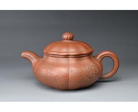 A 20TH CENTURY CHINESE YIXING STONEWARE TEAPOT AND COVER. Of lobed form, incised with flowers, and calligraphic inscriptions,