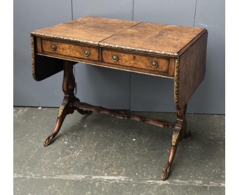 An early 20th century burr walnut and parcel gilt sofa table, on lyre end supports with claw feet, 87x61x74cmH 