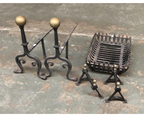 A pair of wrought iron fire dogs with brass ball finials; together with a fire grate, 46cmW and smaller fire dogs 