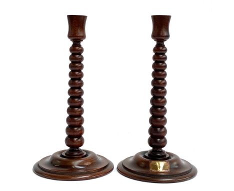 A pair of bobbin turned candlesticks, made from wood from the HMS Lion, bears plaques, 30cmH 