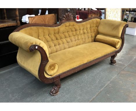 A 19th century sofa, carved mahogany frame, button back with scroll ends, on large paw feet, 230cmW 