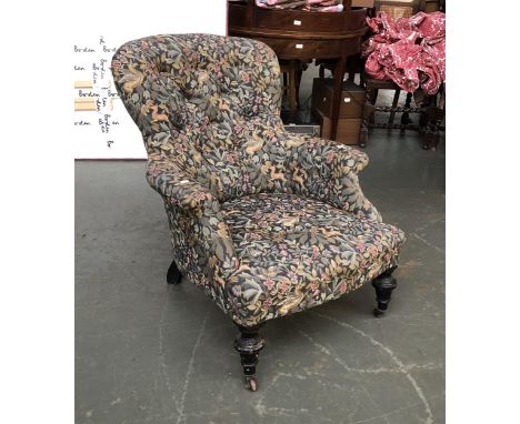 A Victorian button back armchair on turned ebonised legs, upholstered in a William Morris print 