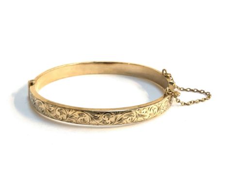 A 9ct gold bangle, floral engraved design, hallmarked for Birmingham 1979, 9.8g 