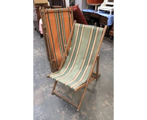 Four vintage beechwood folding deck chairs with striped canvas seats 