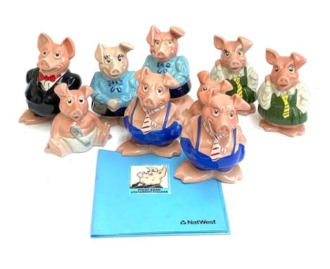 A quantity of nine Wade piggy banks plus statement holder; together with a Poole pottery dolphin and otter. 