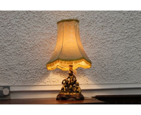 Giltwood effect table lamp and shade with cherub base, height +/-64 cm. 